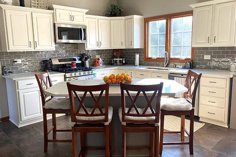 Brousil residence with dining table and white cabinetry