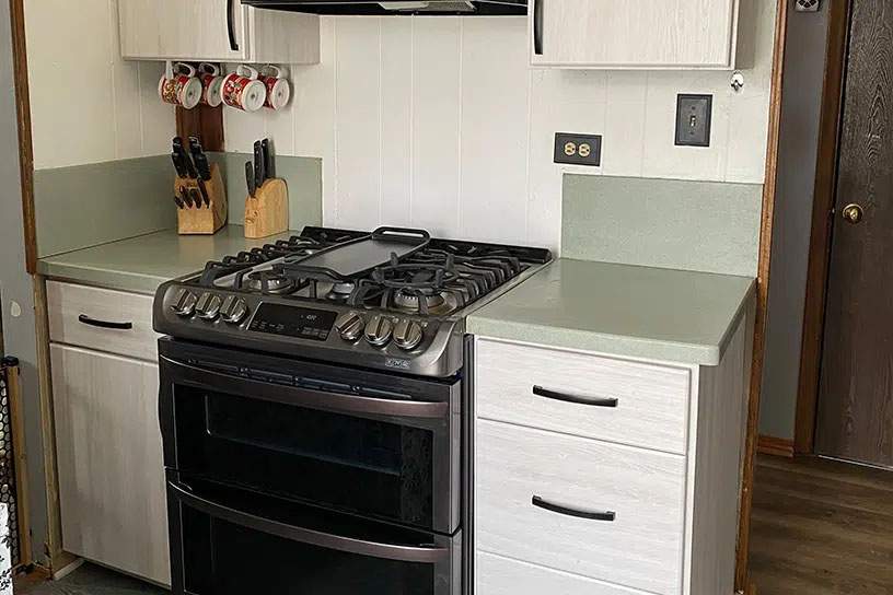 after cabinet resurfacing in white with modern hardware