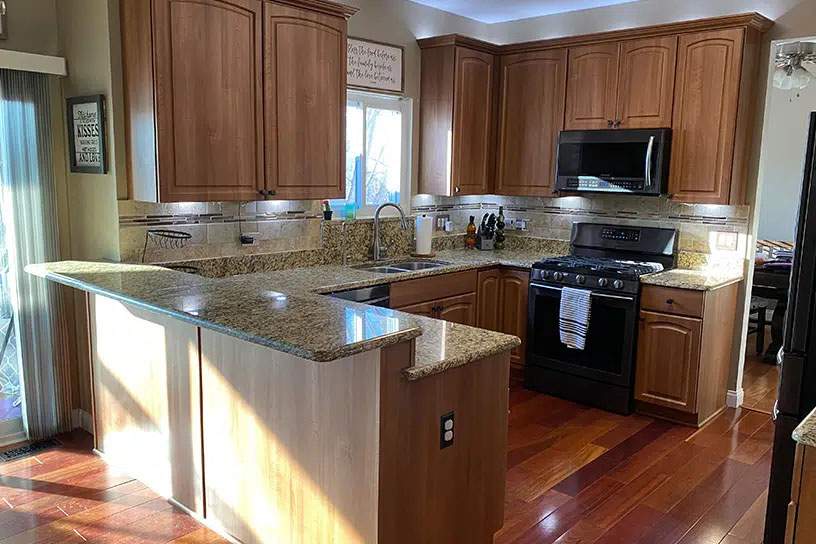 after cabinet resurfacing with brown cabinetry